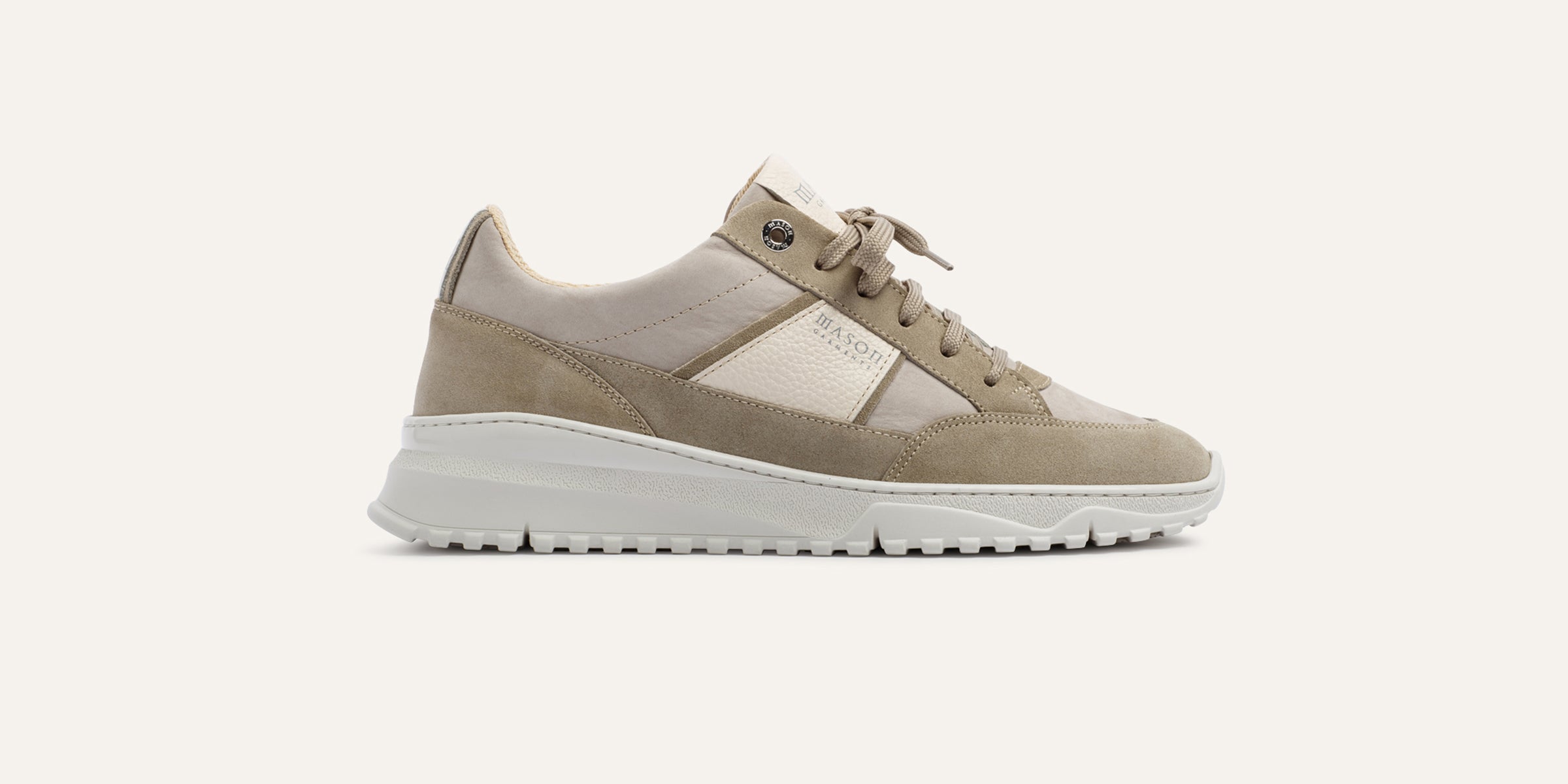 Beige sneaker with white sole on a light background