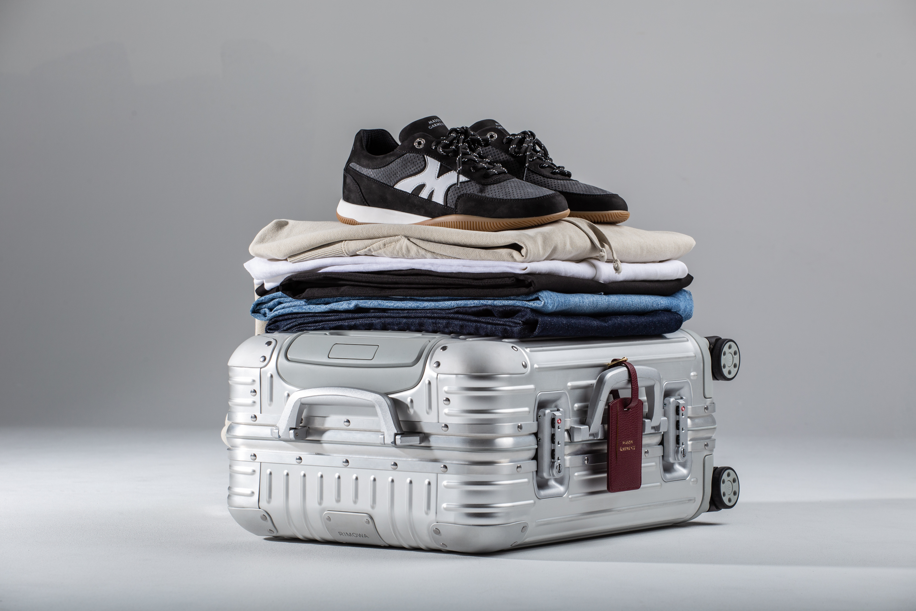 Pair of black Maranello sneakers on the suitcase