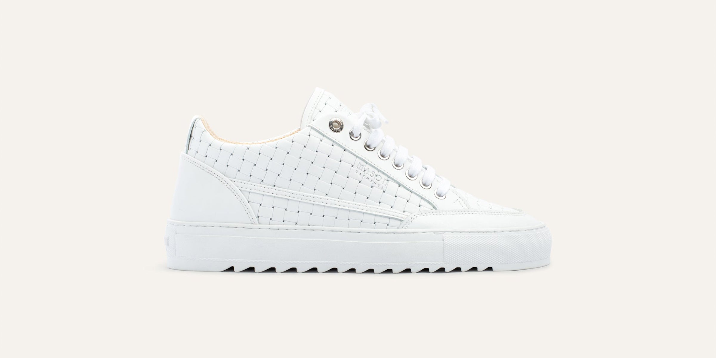 White sneaker on a light beige background