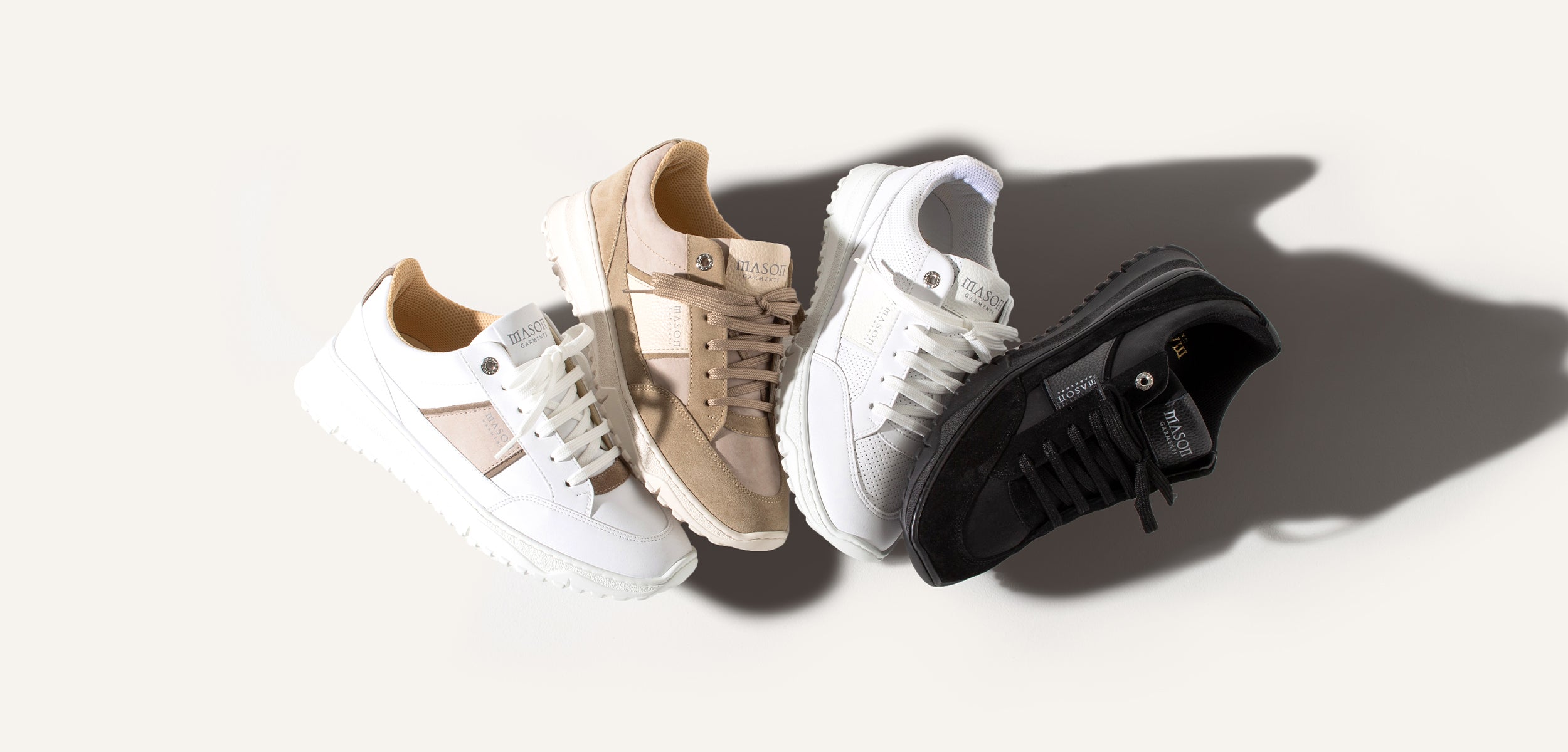 Four sneakers in different colors on a white background
