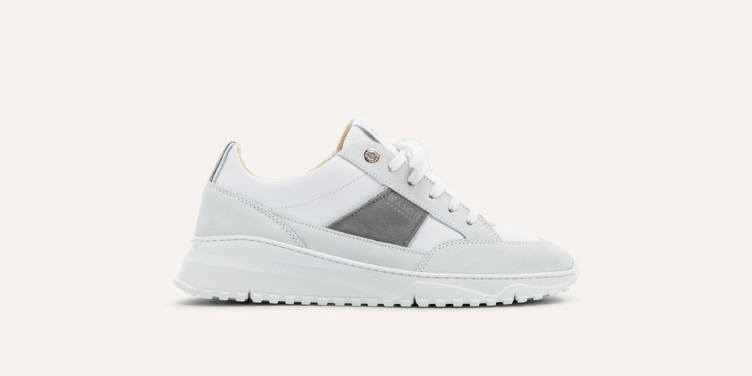 White sneaker with gray patch on a white background