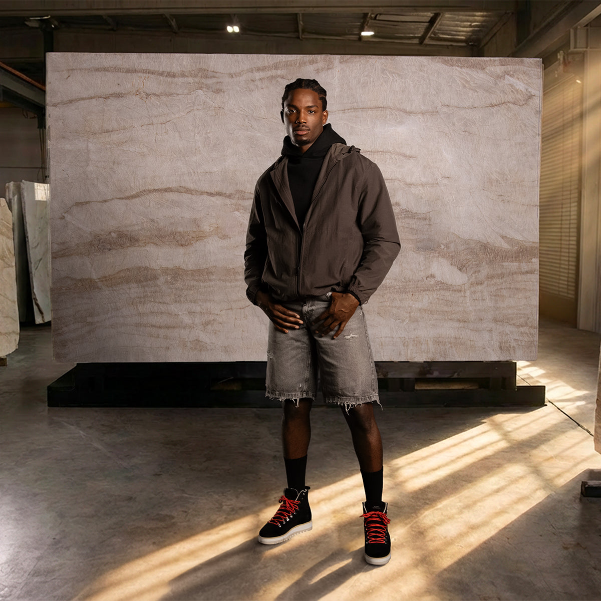 Male outfit with grey jacket, shorts and black boots with red laces.