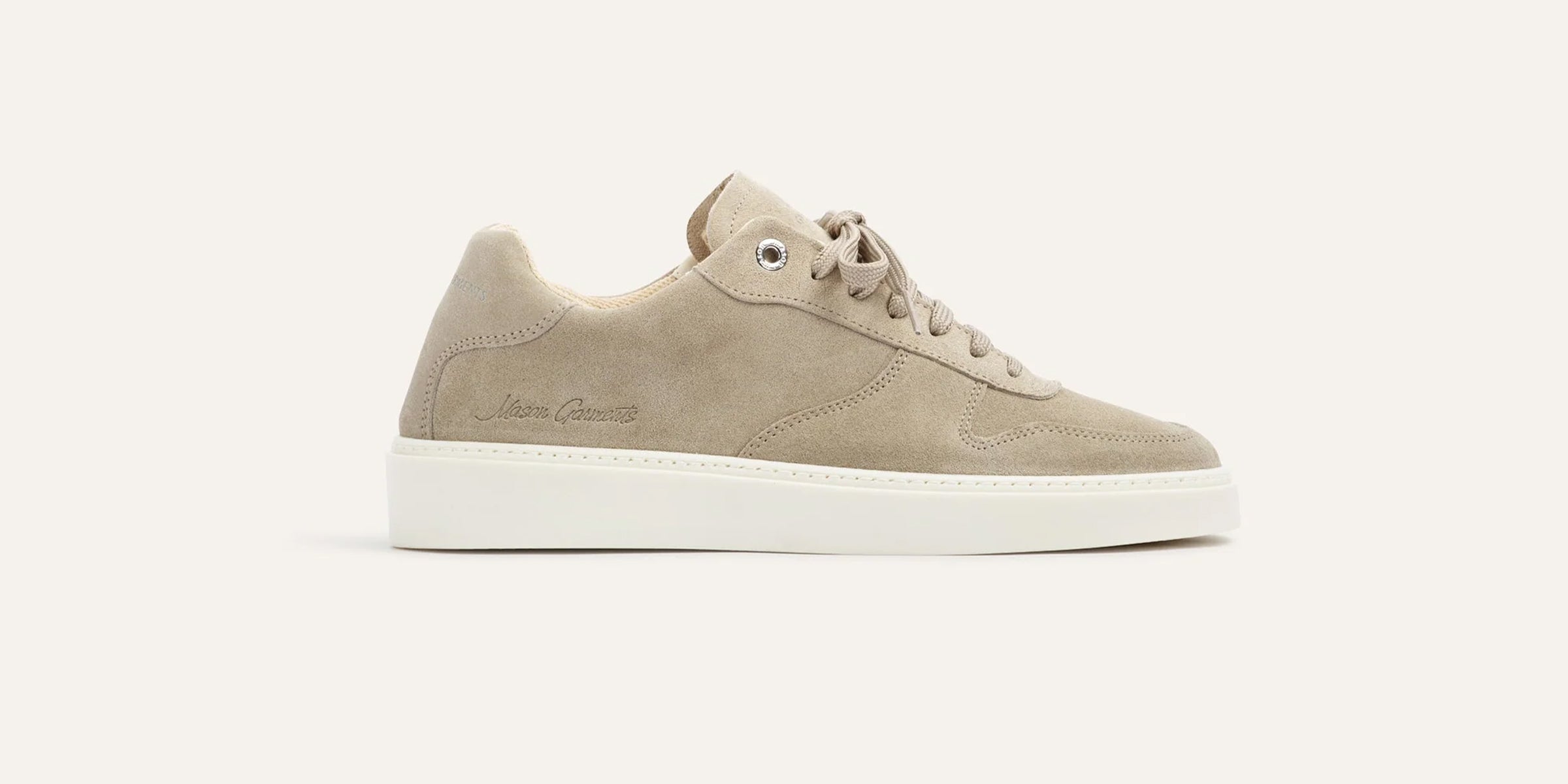 Beige suede sneaker with white sole on a light beige background