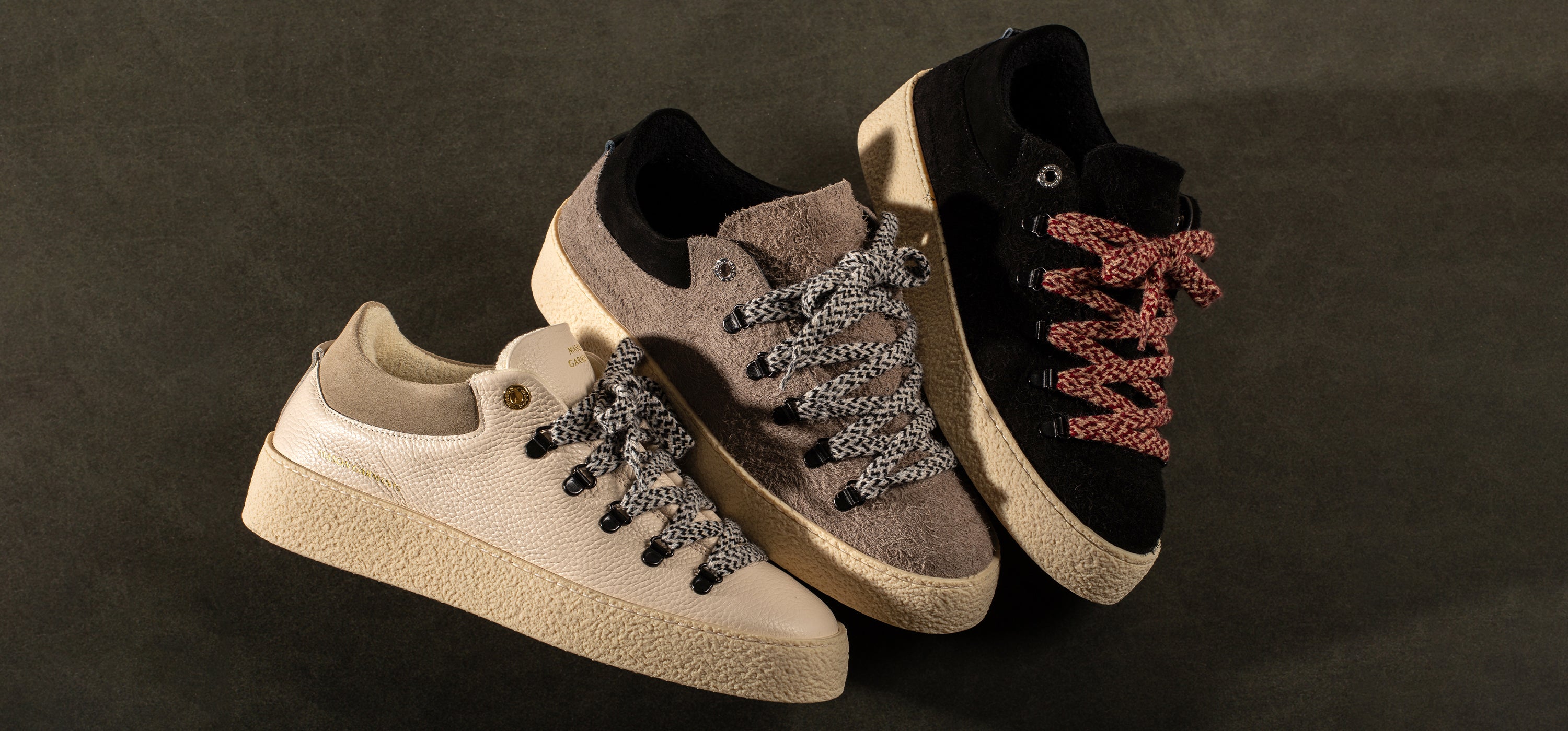 Flatlay of three low boots in beige, brown and black